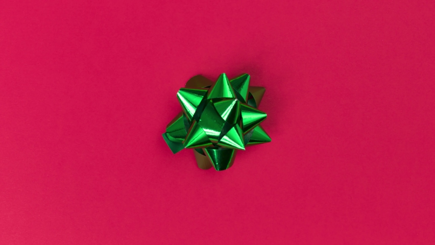 Unwrapping gift revealing a green screen - Stop Motion Animation - Green bow on a red background | Shutterstock HD Video #1072684973