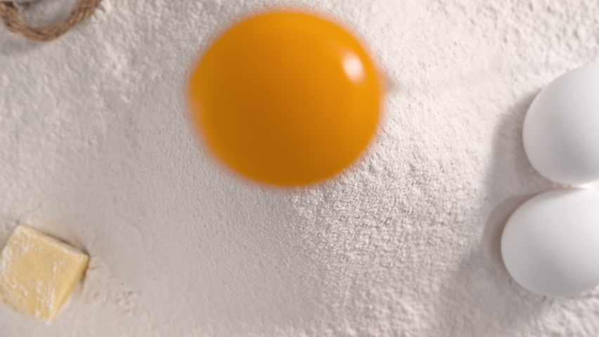 Raw Egg Yolk Falling into Pile of Flour Making Hole - Top Shot in 1000fps (Phantom Flex) Royalty-Free Stock Footage #1072685432