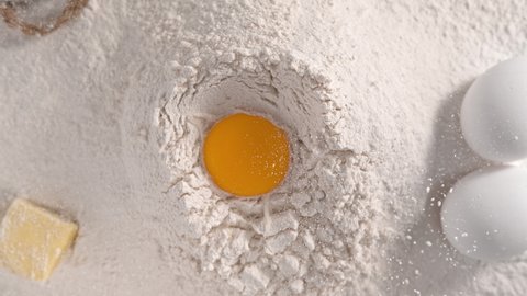 Raw Egg Yolk Falling into Pile of Flour Making Hole - Top Shot in 1000fps (Phantom Flex)