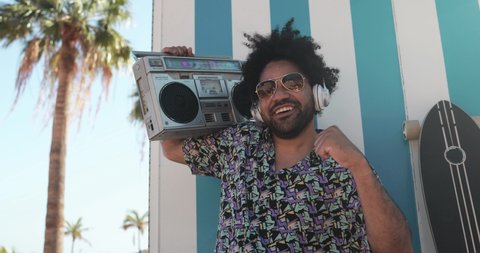 Young african american man dancing outdoor with vintage boombox - Party and summer lifestyle concept