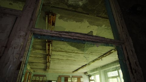 Abandoned and destroyed classroom of Pripyat elementary school, tilt down