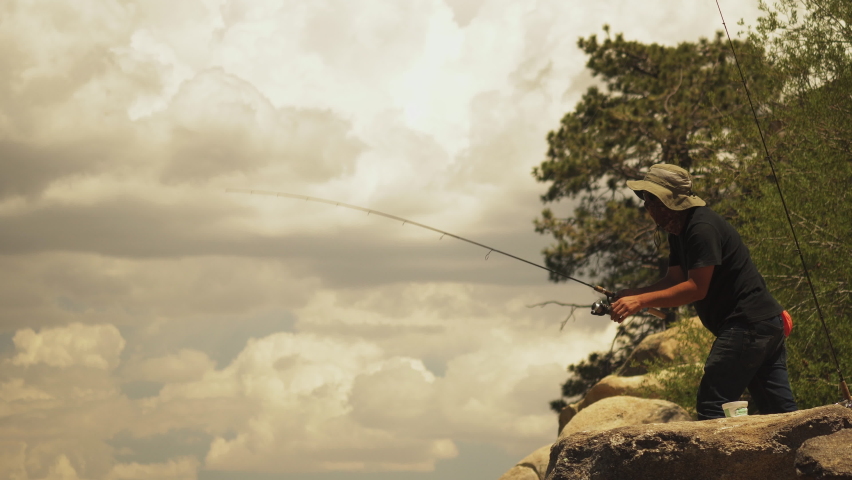 Fishing man recalling the line fails to catch the fish at the last moment
