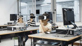 Children sitting in classroom and using virtual reality headset. Excited kids imagining that they eating and plucking something. VR technology in education concept. - Powered by Shutterstock - Get 15% off with code: PIKWIZARD15