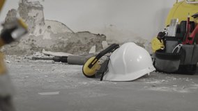 house renovation concept, helmet and safety headphones, air compressor and construction tools, video panning