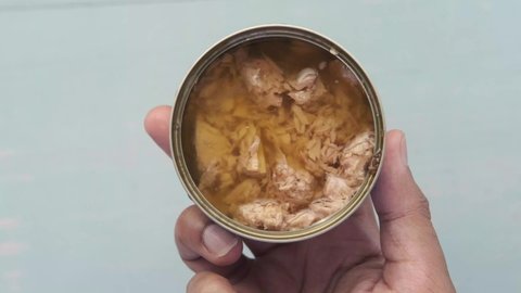 canned tuna on a wooden table 