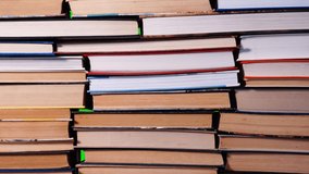 Lots of pile of books growing on green chroma key background. Teaching and learning science concept. A stack of books on a wooden table, stop motion, time laps. - Powered by Shutterstock - Get 15% off with code: PIKWIZARD15