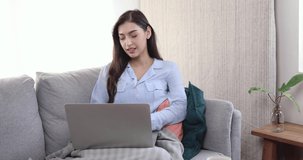 Young business Asian woman working at home with laptop.