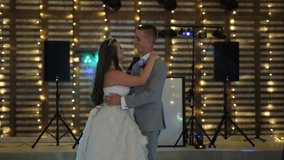 Touching moment as a bride and groom share their first dance as man and wife. - Powered by Shutterstock - Get 15% off with code: PIKWIZARD15