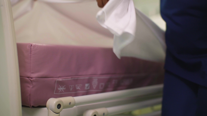 CU Female Nurse Making Hospital Bed. High quality