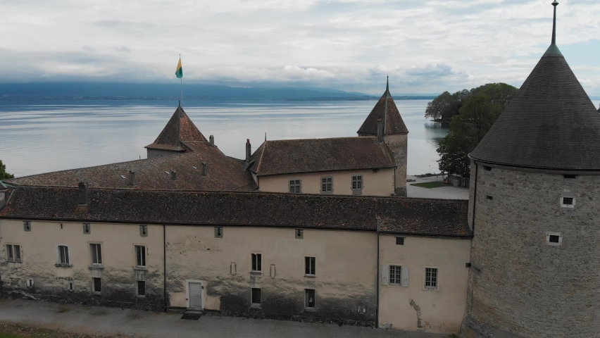 Drone flying over the ancient castle of Rolle on Geneva (Leman) Lake with french alps on background