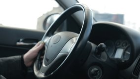 Video, woman hands drive a car, fingers lie on the steering wheel, beautiful fingers female hands