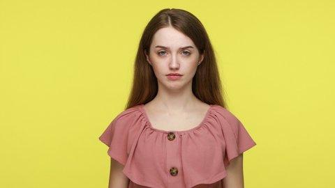 Unhappy woman in elegant dress holding her breath grabbing nose with fingers, feeling unpleasant odor, disgusting smell of farting and dirt. Indoor studio shot isolated on yellow background.