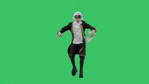 Portrait of courtier gentleman in black vintage suit, white wig and the mask, dancing merrily with fan in his hands. Young man posing in studio with green screen background. Full lenght. Slow motion.