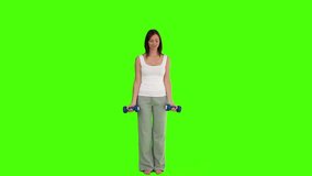Chromakey footage of a brunette doing some exercise with dumbbells
