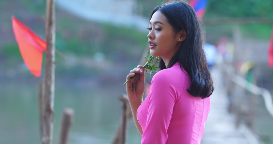 Vietnamese Woman In Traditional Dress Pose And Looking At Camera

