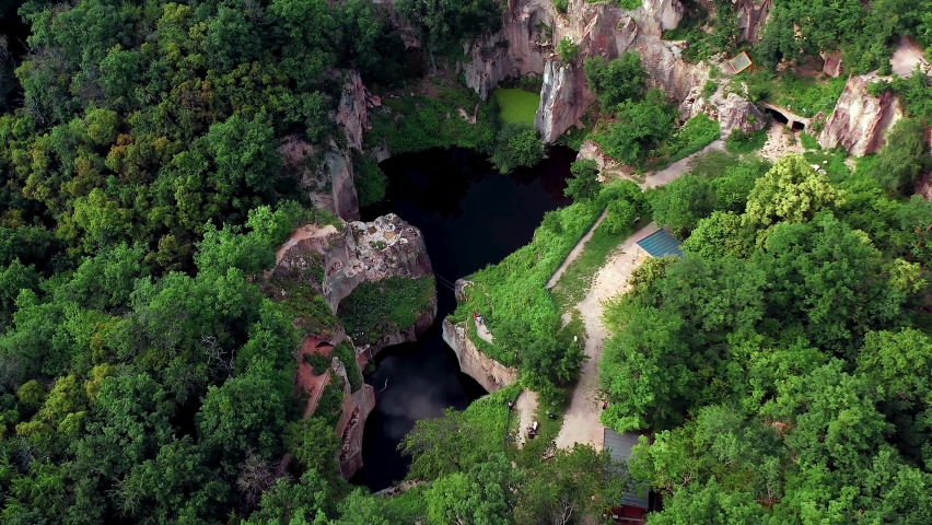 Flooded ancient stone quarry in Hungary near Sarospatak. Hungarian name is: Megyer-hegyi tengerszem. Small lake at the top of a hill. View from the top. Fantastic nature attraction in Tokaj area.