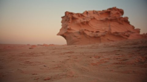 Girl walking barefoot in the desert wearing ankle bracelet fossil dunes UAE Abu Dhabi Dubai