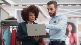 Clothing Store: Businesswoman Uses Tablet Computer, Talks to Visual Merchandising Specialist, Collaborate To Create Stylish Collection. Small Business Fashion Shop Sales Manager Talks to Designer. - Powered by Shutterstock - Get 15% off with code: PIKWIZARD15