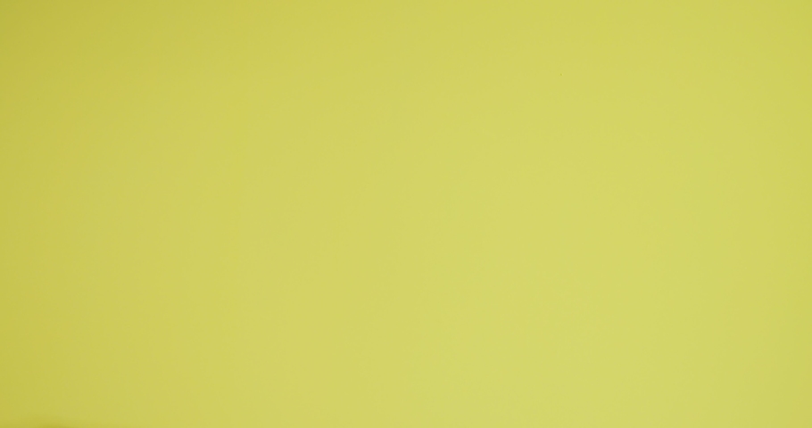 Riding young man on yellow background Royalty-Free Stock Footage #1072800104