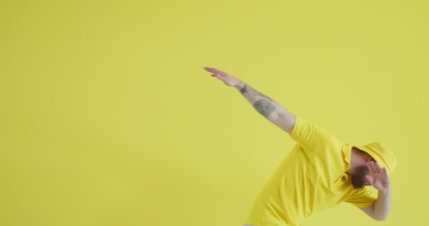 Riding young man on yellow background
