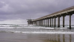 4k video. View of La Jolla pier in California. Waves on a cloudy day