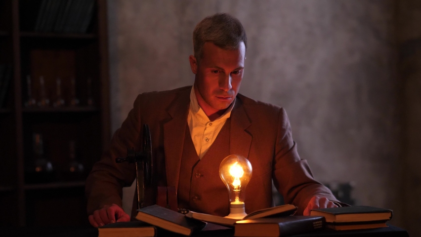 Thomas Edison produces electricity and reads a book.