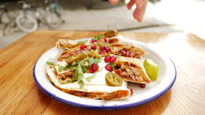 Eating quesadilla in traditional mexican cuisine restaurant outdoor terrace
