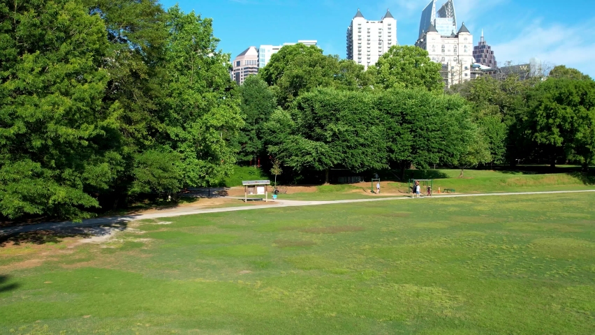 A drone shot taken from Piedmont Park in Atlanta showing the surrounding architecture.