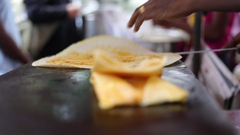 Dosa being rolled to serve. South indian food (high speed)