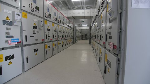 Motion along long hallway with switch gear closed in metal cabinets at contemporary electricity distribution substation