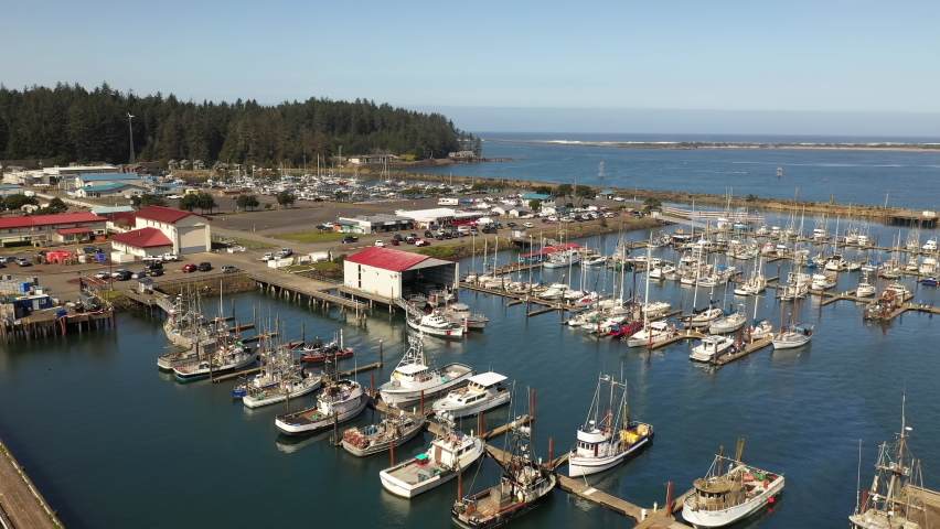 Fly with drone over buildings and boats at Charleston Harbor, Oregon. Aerial