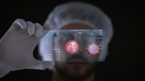 Male Scientist looking at a holographic Coronavirus interface with patient information and Covid 19 3D model rotating. Pandemic Research, augmented reality, futuristic technology concept. - Powered by Shutterstock - Get 15% off with code: PIKWIZARD15