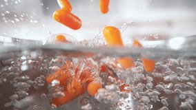 Frozen Baby Carrots Falling into Pot with Boiling Water in Macro 1000fps (Phantom Flex) - Powered by Shutterstock - Get 15% off with code: PIKWIZARD15