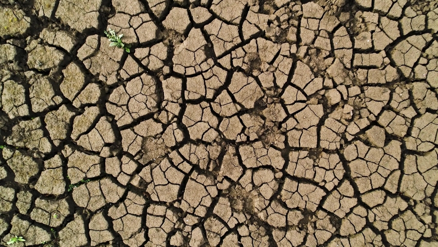 Aerial top view of the ground during the dry season. Shot. Drought concept, deep cracks in soil, lack of moisture. Royalty-Free Stock Footage #1072830200