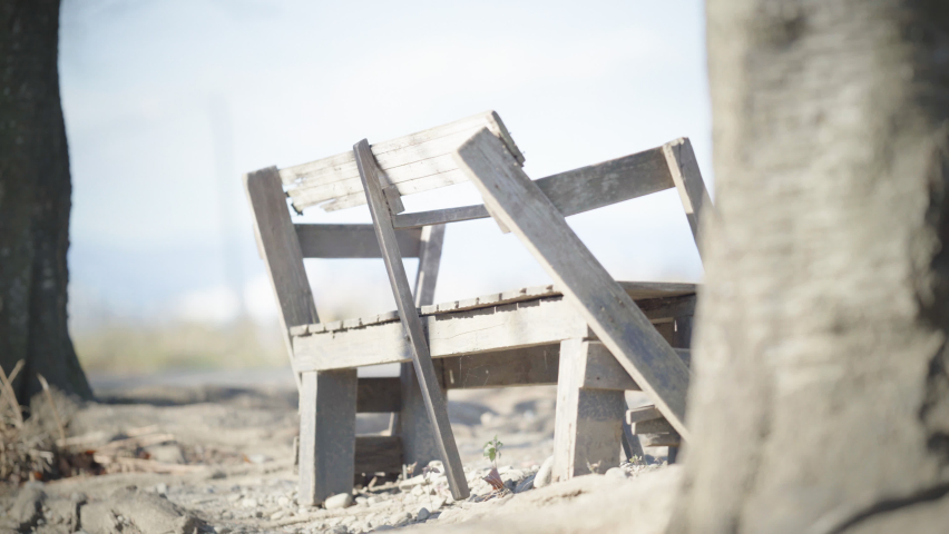 A broken chair, nobody, the wind blows quietly (