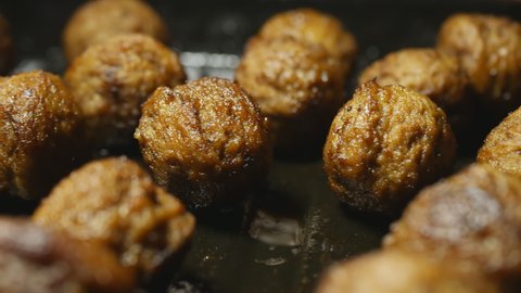 fried meatballs on a metal baking sheet. Filming Dolly.