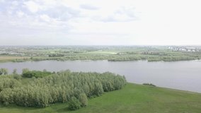 Drone footage of flying up at the river and big forest in the Netherlands