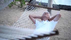 Asian senior elder man relax at beach resort hammock retirement vacation - Powered by Shutterstock - Get 15% off with code: PIKWIZARD15