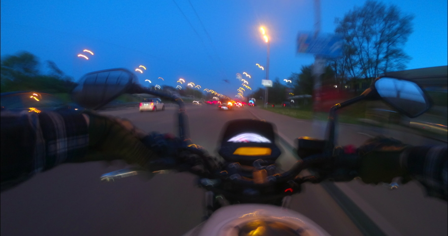 Hyper lapse of night bike driving POV on the streets lane splitting. Motorcycle fast driving.
