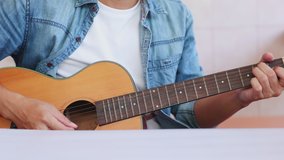Male vlog influencer performance music show, teaching how to play guitar, streaming to internet online audience listening at home. Man sings a song with smile face. Home entertainer, blogger concept.
