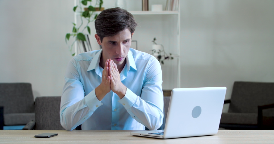 Shocked frustrated caucasian millennial business man student feel stressed look at computer screen worried of problem read bad online news receive failed exam results concept sit at home office table Royalty-Free Stock Footage #1072858478