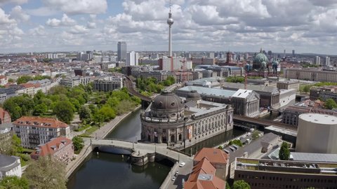 BERLIN, GERMANY - May 17 2021: Time lapse video showing tourist boats on Spree river in front of the Bode museum and TV tower .