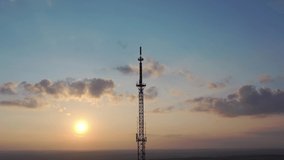 Video TV radio tower against the backdrop of the setting sun. Drone video.