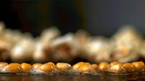 Super slow motion popcorn grains explode. Macro background.Filmed on a high-speed camera at 1000 fps. High quality FullHD footage - Powered by Shutterstock - Get 15% off with code: PIKWIZARD15