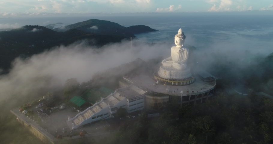 Aerial view 4k Footage Fog over Big Buddha of Phuket Thailand.Big Buddha white statue in the fog.Big Buddha Phuket is the one of landmarks on Phuket Thailand. | Shutterstock HD Video #1072879469