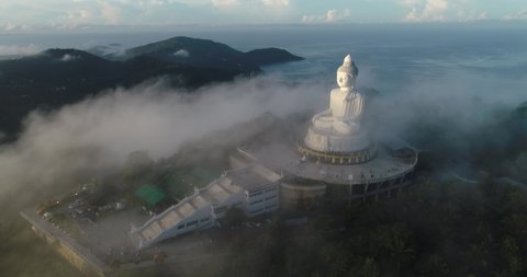 Aerial view 4k Footage Fog over Big Buddha of Phuket Thailand.Big Buddha white statue in the fog.Big Buddha Phuket is the one of landmarks on Phuket Thailand.