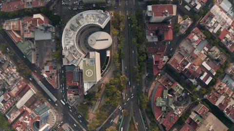 Top down view of streets in Mexico city. Cars driving in streets in low traffic hours. Drone camera slowly moving forward.