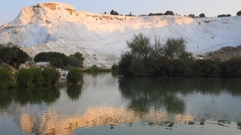 Green lake in Pamukkale's white travertines.Calcium carbonate travertine terrace formations.Sedimentary rock deposited by waters from the hot spring.Cotton castle natural world heritage site carbonate