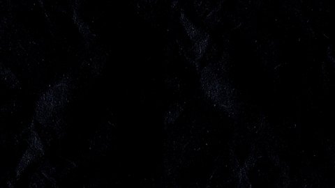 Rough paper texture in black background, animation in stop motion effect. Grainy texture.