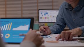 Closeup hand group asia people busy account team work late night audit check notebook and online sale cost budget profit statistics paper on table desk in staff idea in analyst job career cowork - Powered by Shutterstock - Get 15% off with code: PIKWIZARD15